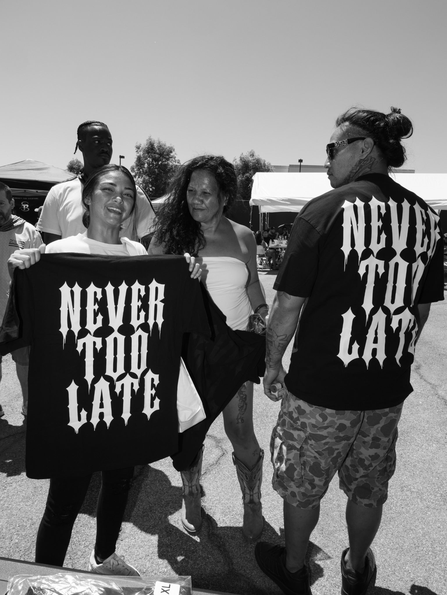 Community members with Never Too Late shirts