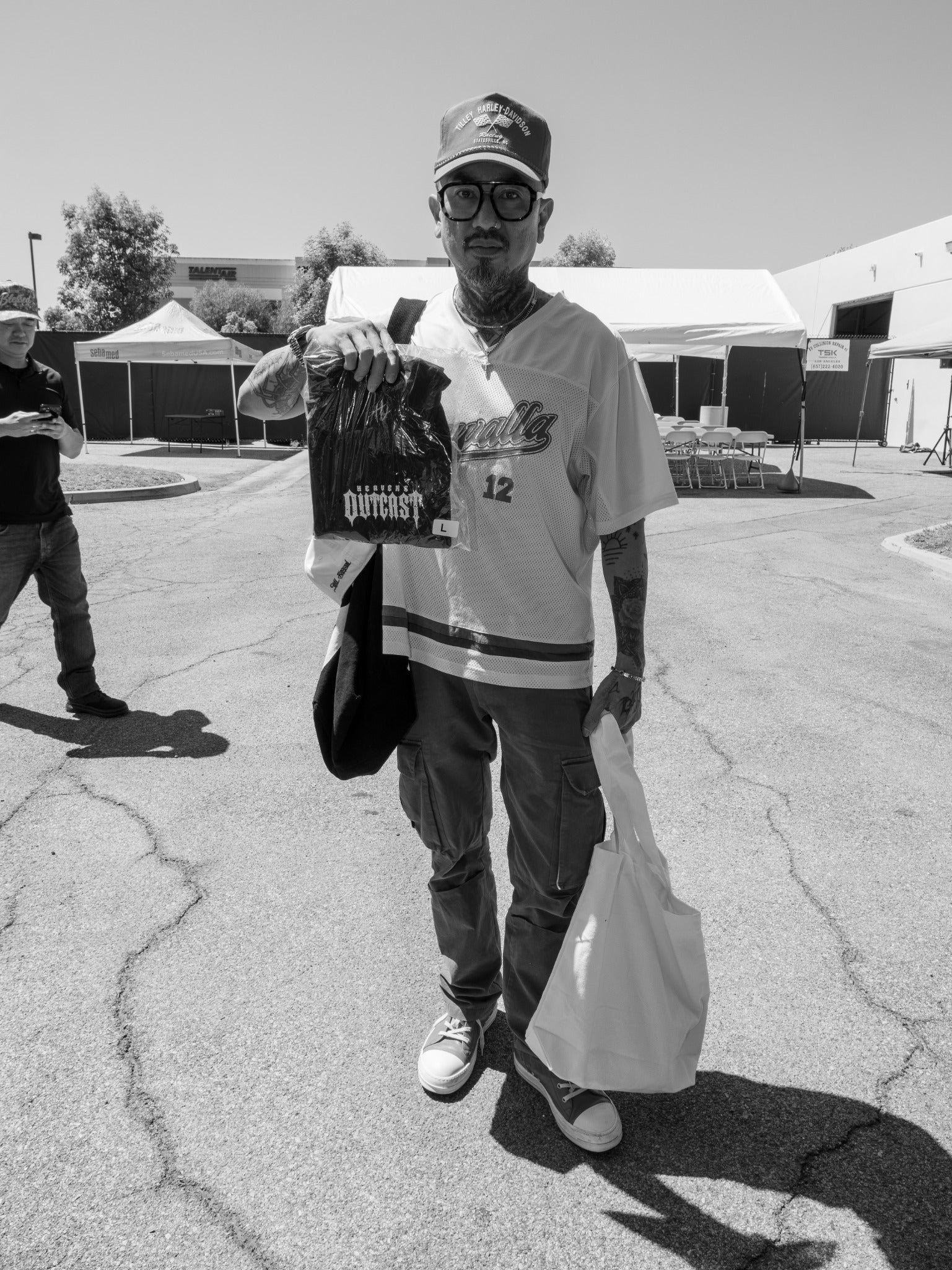 Heaven's Outcast community member holding event merchandise